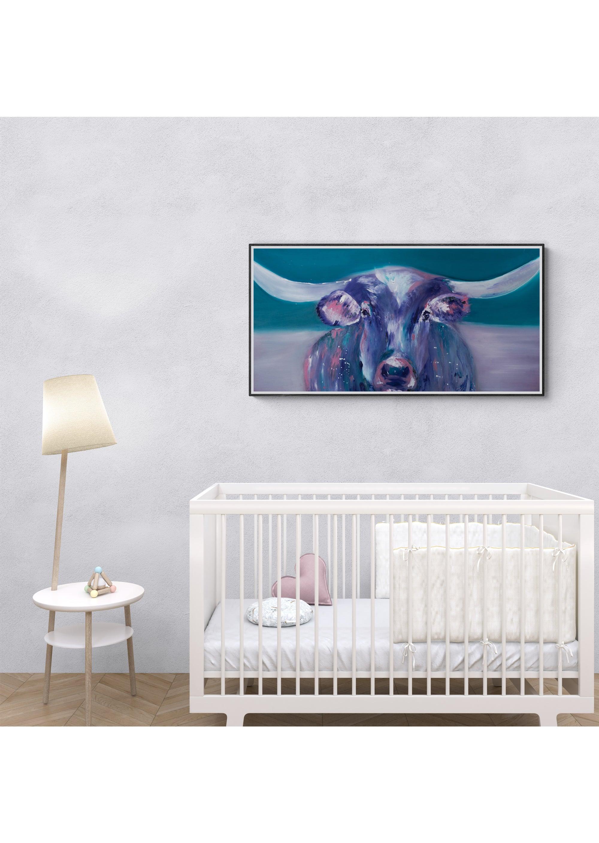 A minimalist nursery featuring a white crib, round side table with lamp and decor, and a large Cow Life Inspired Gallery Wrap Canvas by Artsy Ems Designs displayed on a light gray wall.
